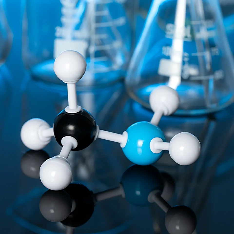 Molecular model in front of laboratory flasks
